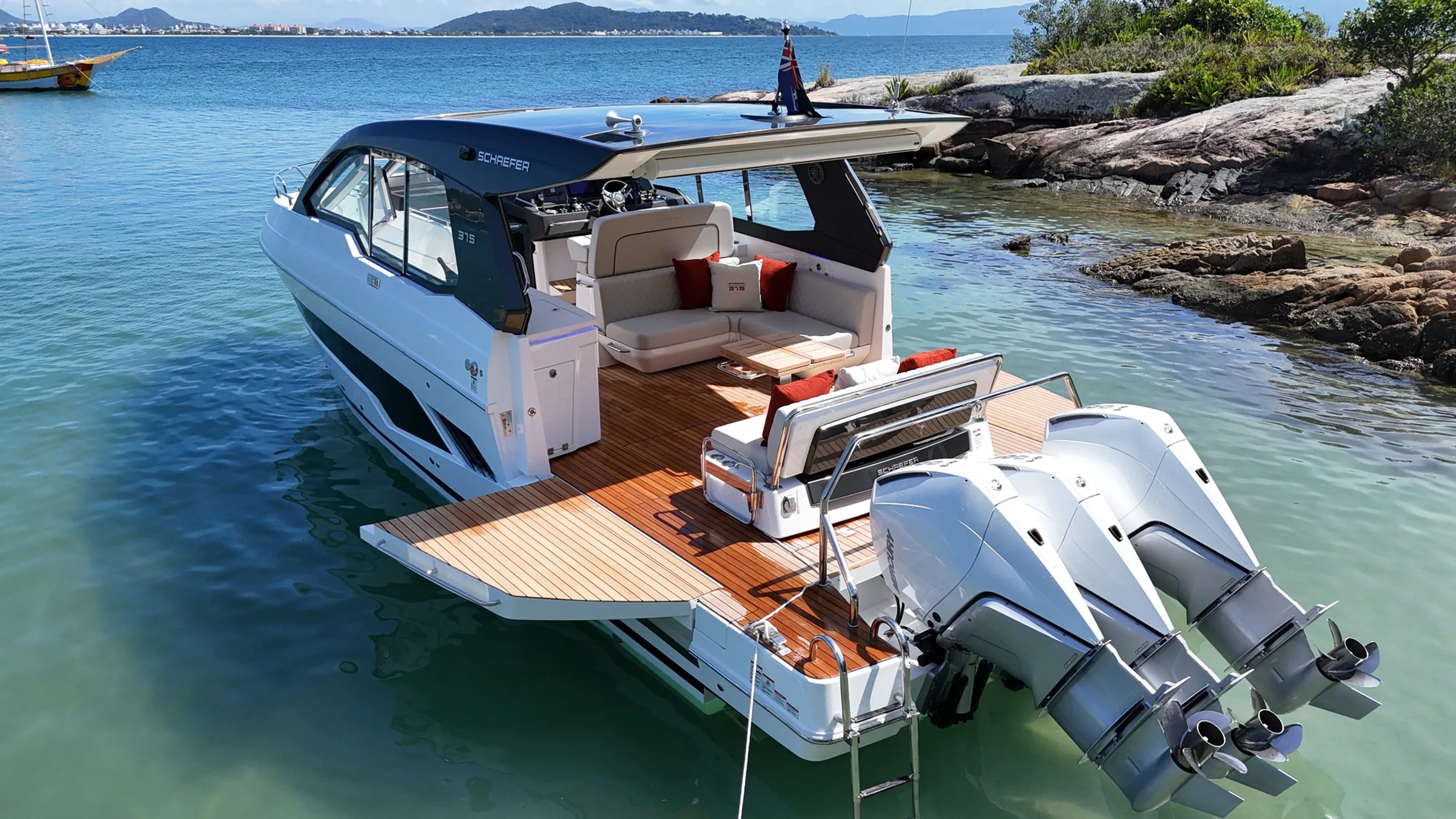 Schaefer 380 with both side balconies open in shallow turquoise water