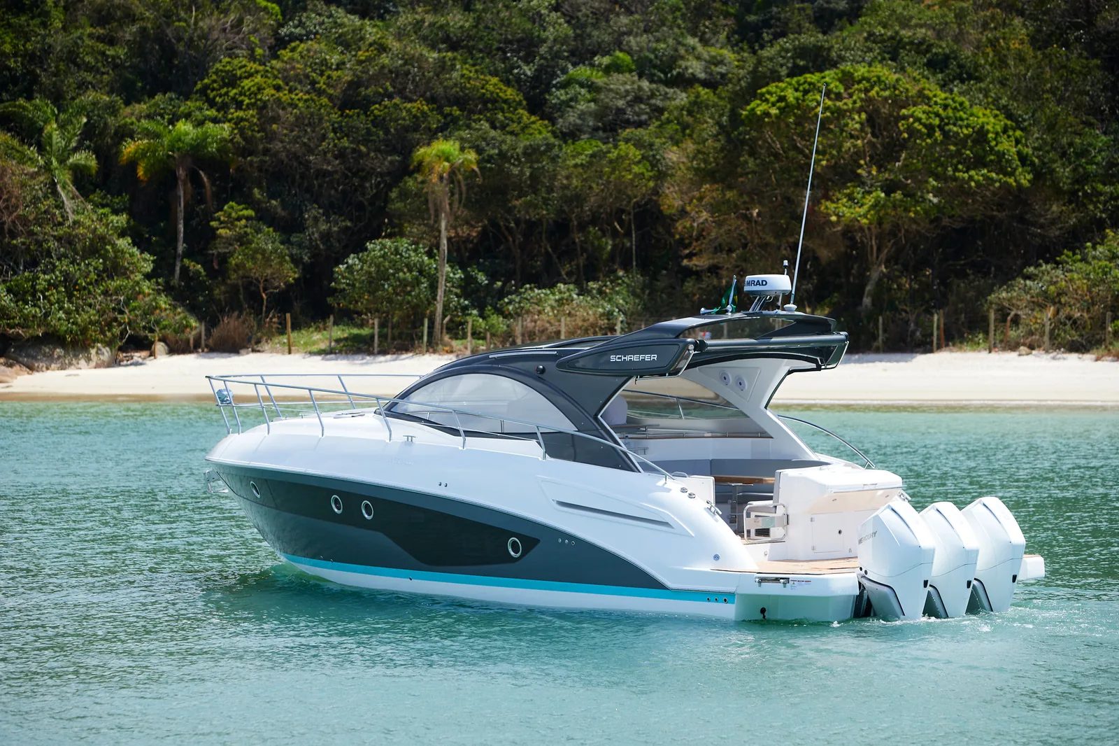 Schaefer 400 with outboards at anchor near the beach