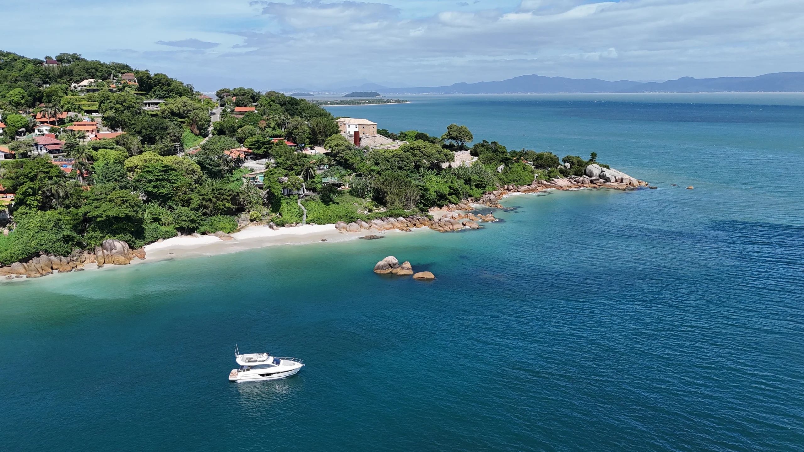 Schaefer 450 at anchor in a bay below a hillside village