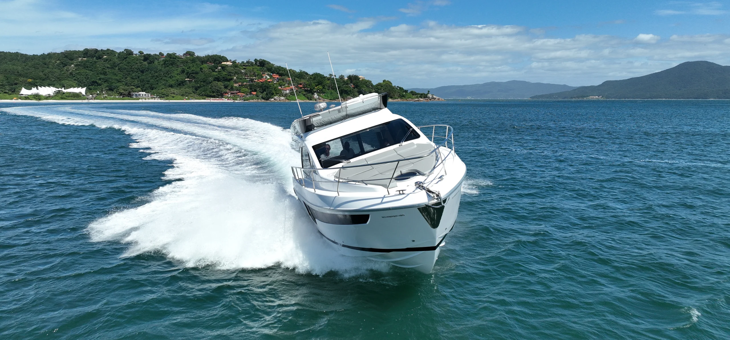 Schaefer 450 turning at speed with the coast behind