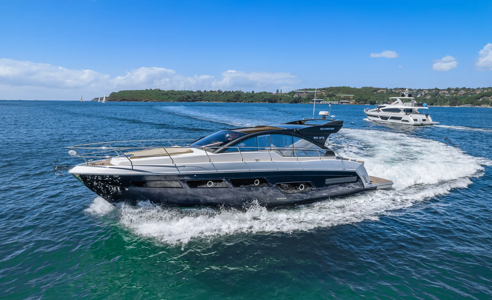 Schaefer 510 GTS at speed with the harbour shoreline behind