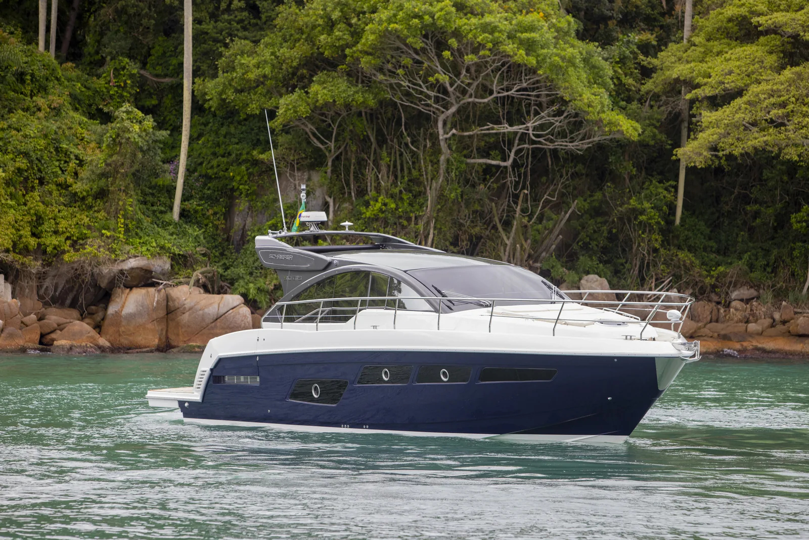 Schaefer 510 GTS at anchor with a rainforest shore behind