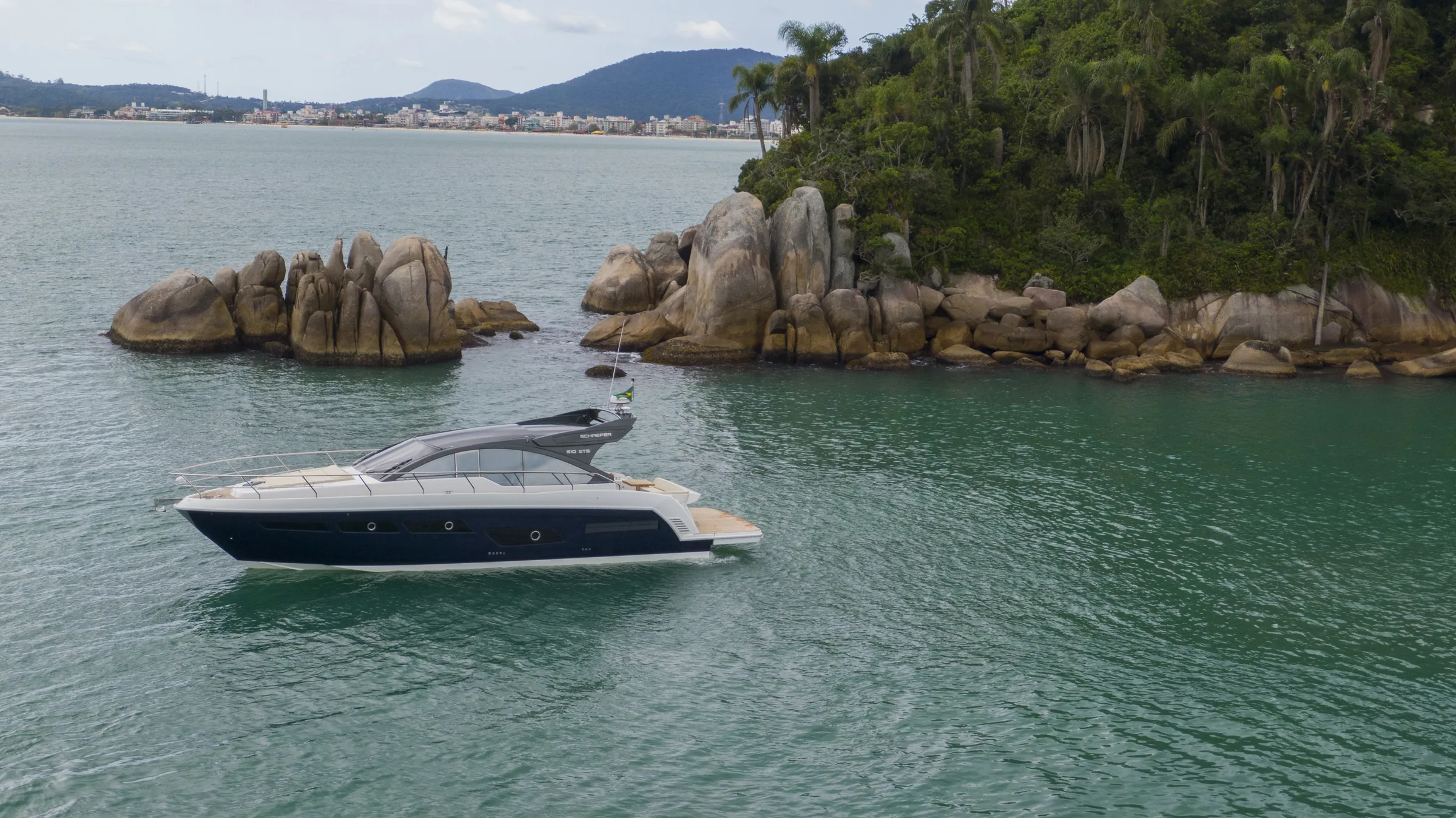 Schaefer 510 GTS at anchor beside granite boulders
