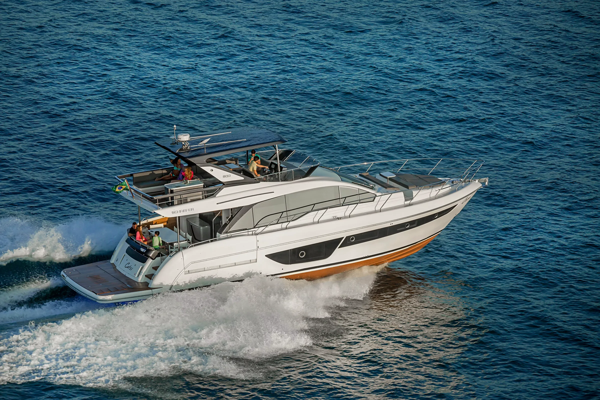 Schaefer 600 at speed with guests on the flybridge and cockpit