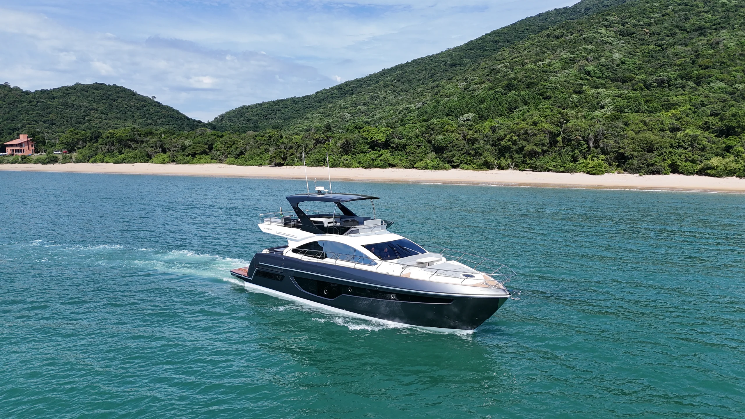 Schaefer 660 cruising past a beach
