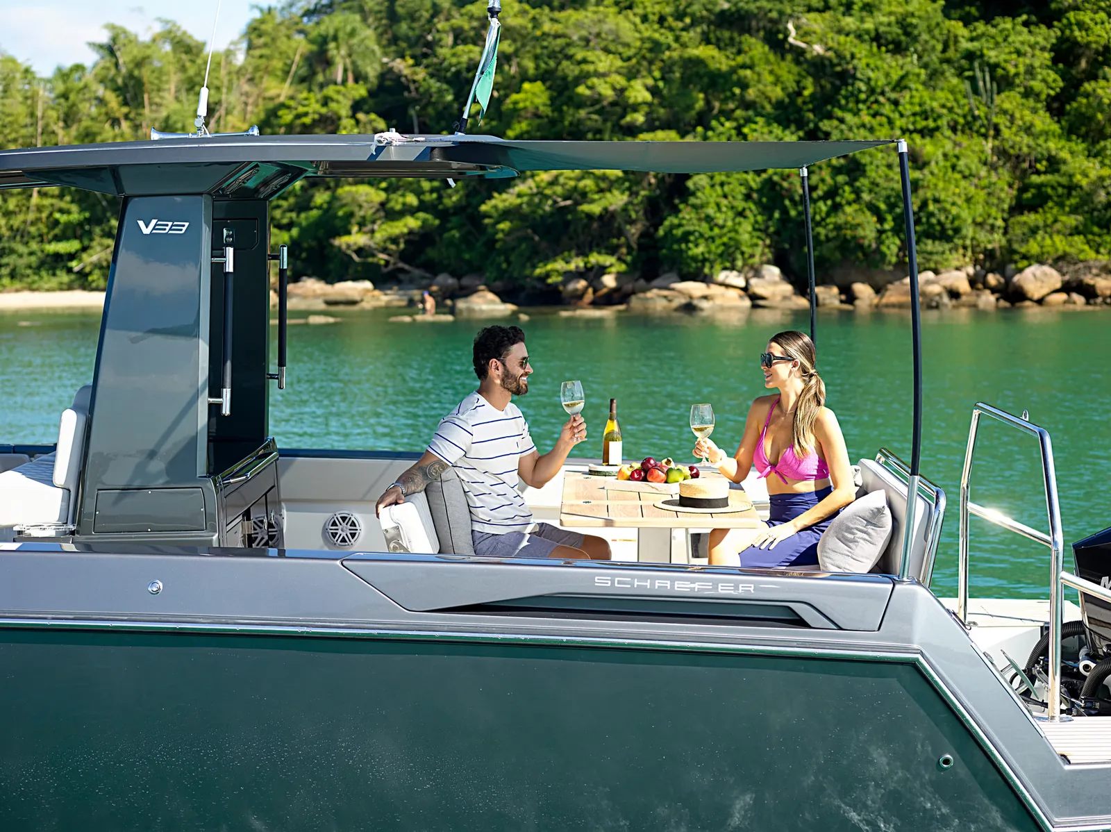 Guests dining at the aft table under the Schaefer V33 hardtop
