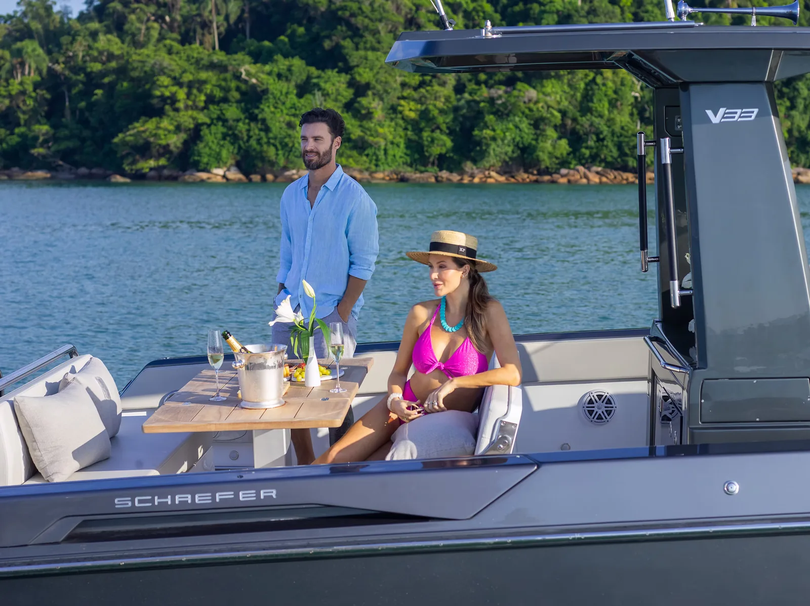 Couple relaxing at the aft dinette of the Schaefer V33