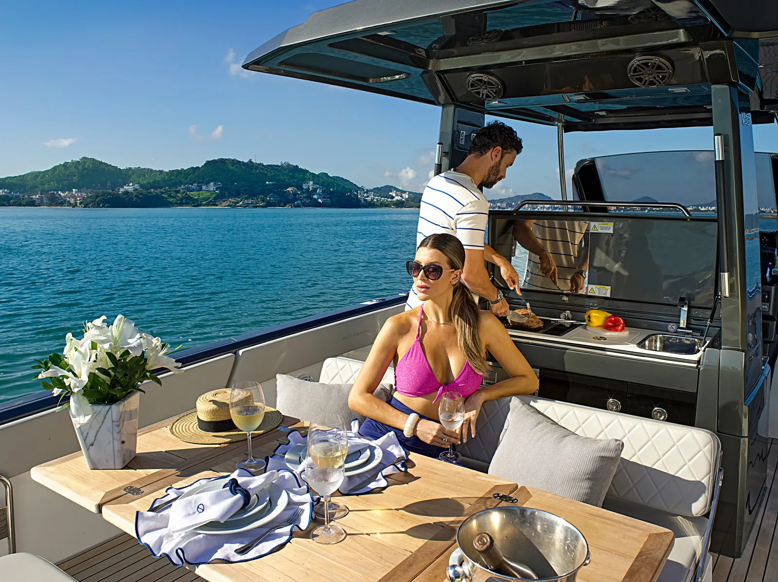 Guests around the aft deck and galley station of the Schaefer V33