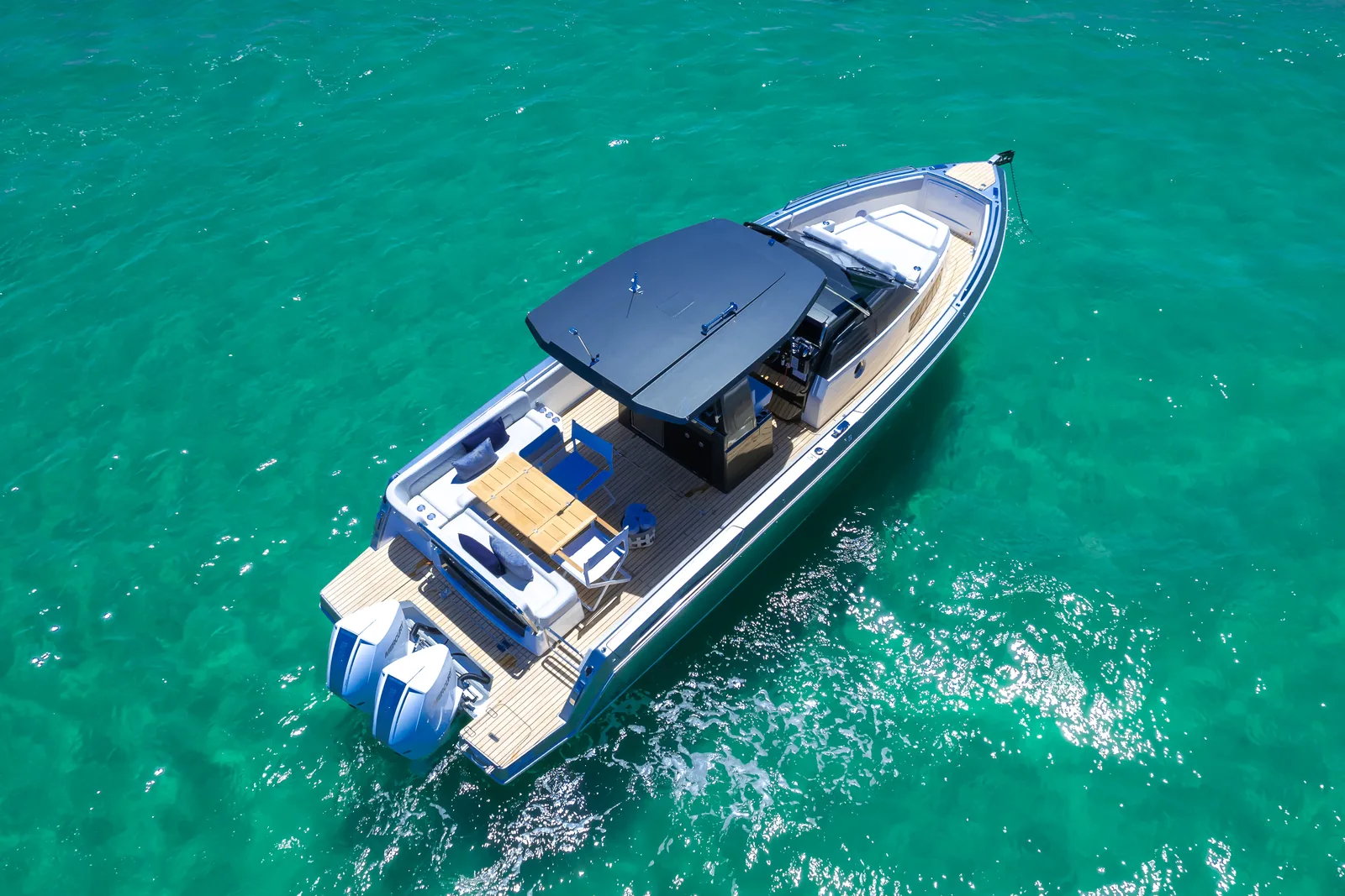 Aerial view of the Schaefer V33 running across turquoise water