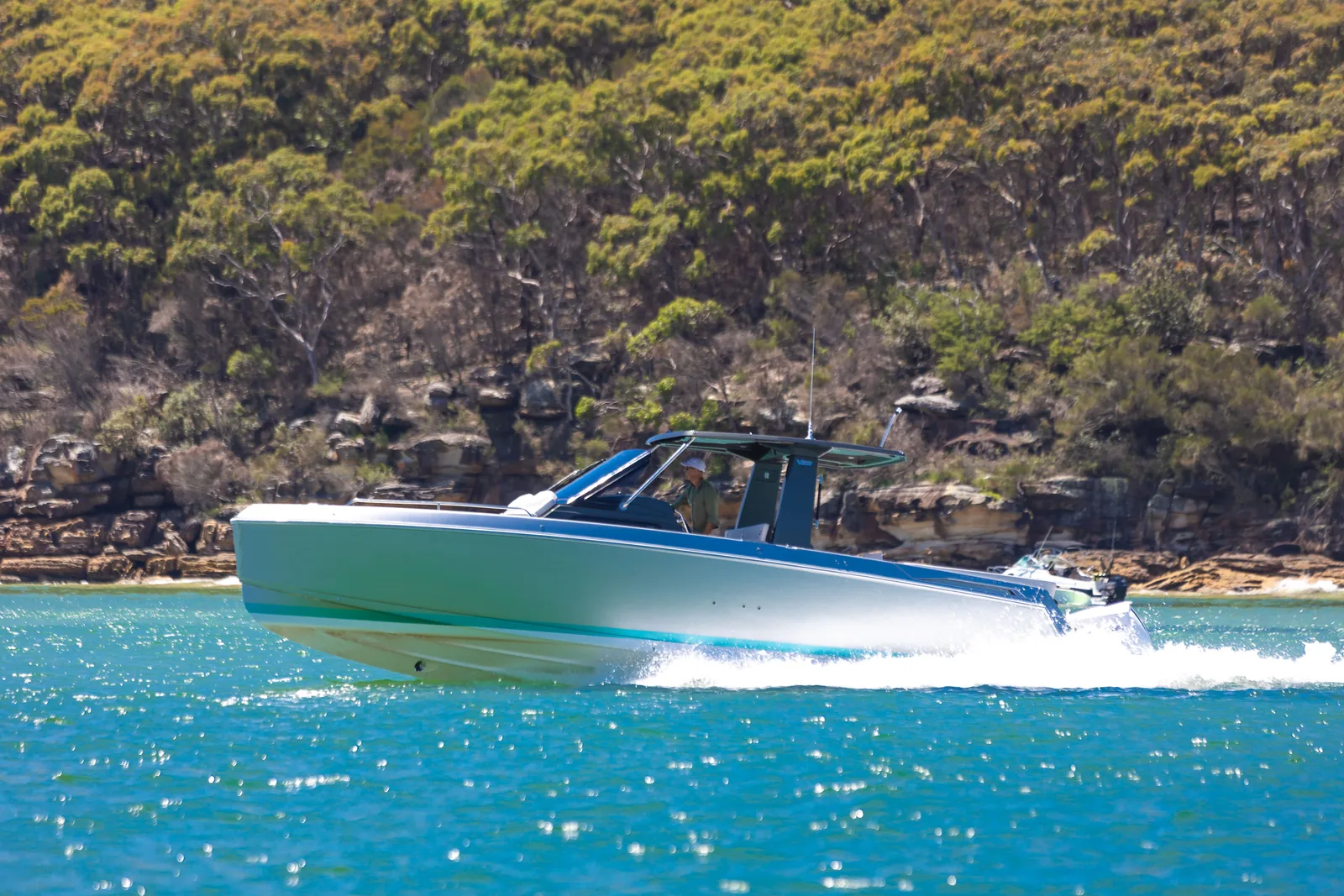 Schaefer V33 at speed with the shoreline behind