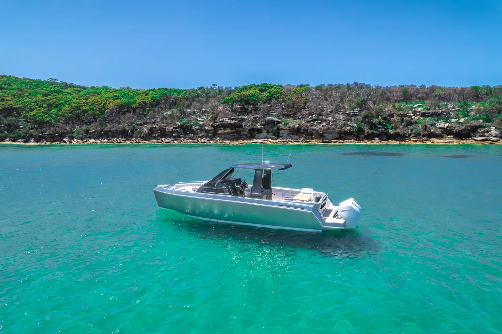Schaefer V33 at anchor off a bushland shoreline