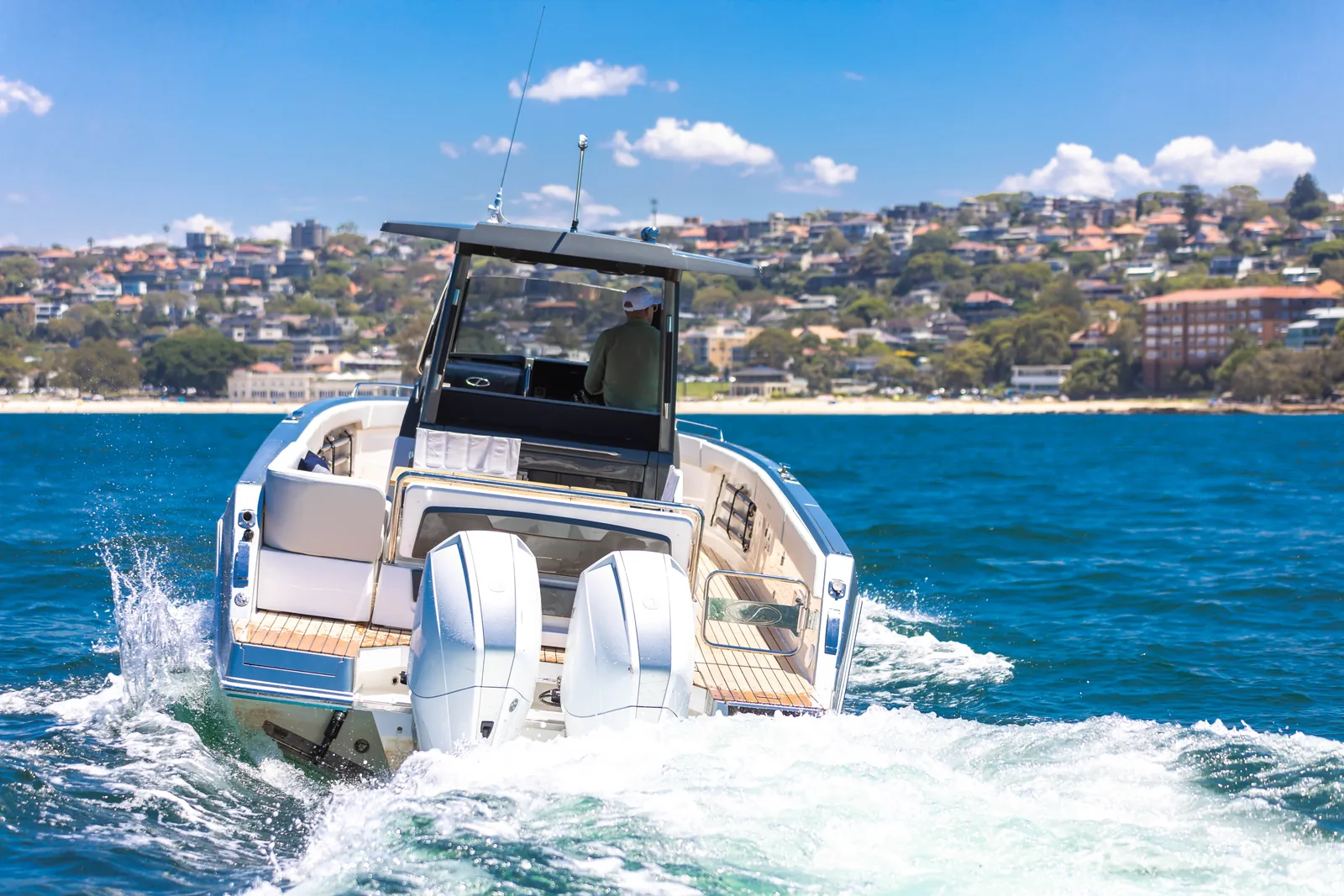 Stern view of the Schaefer V33 at speed with twin outboards