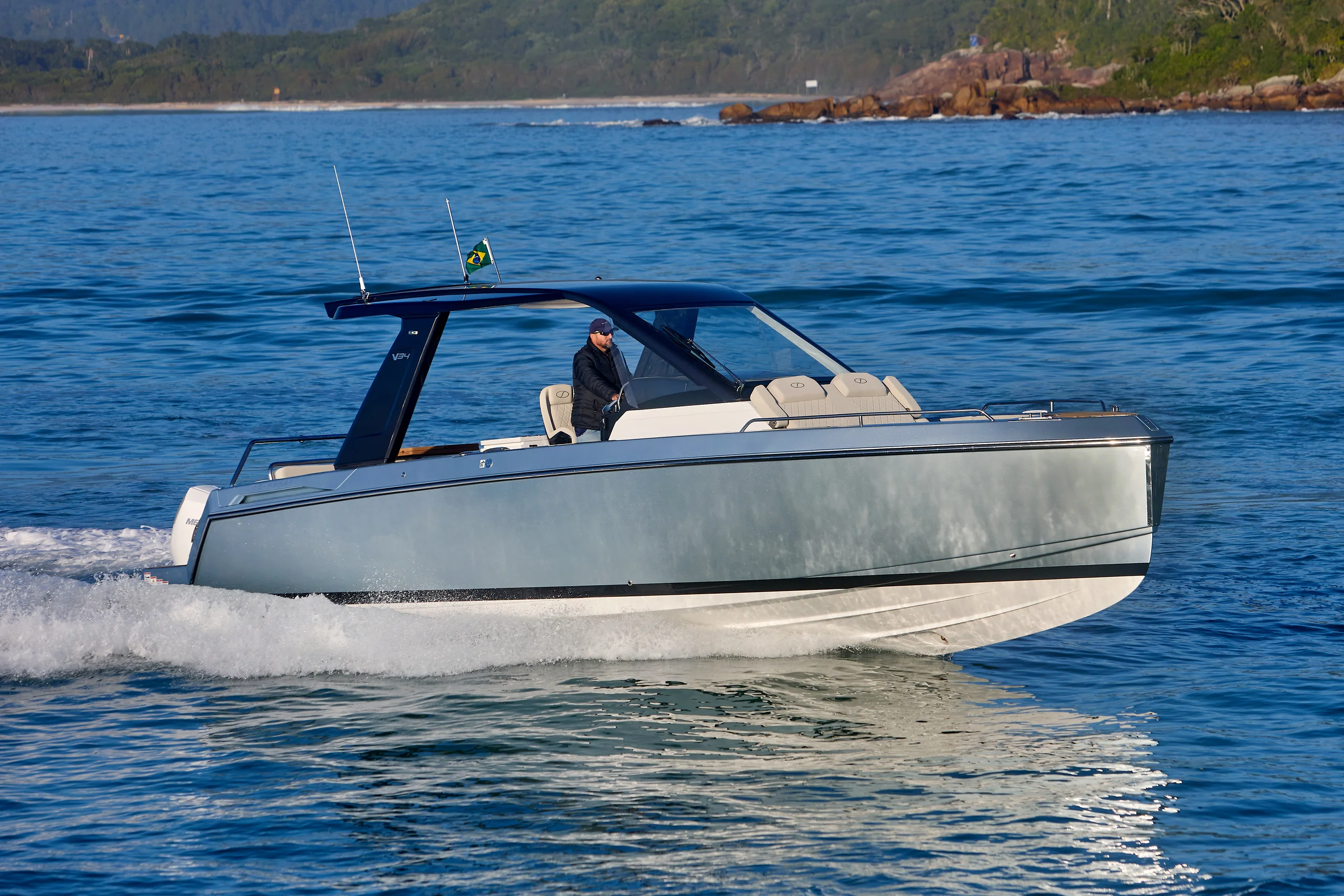 Schaefer V34 running at speed along a forested coastline