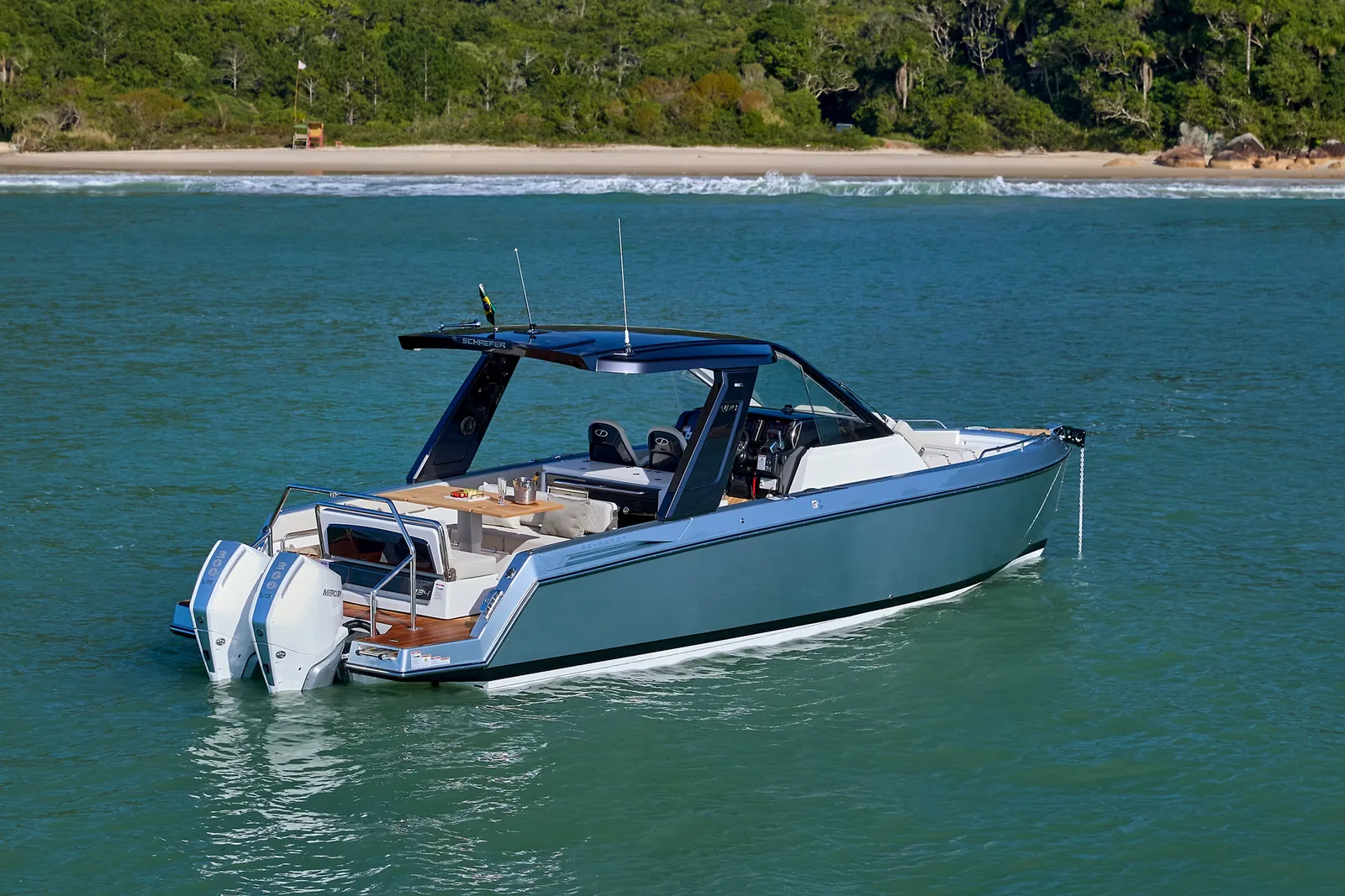 Schaefer V34 at speed with a beach and headland behind