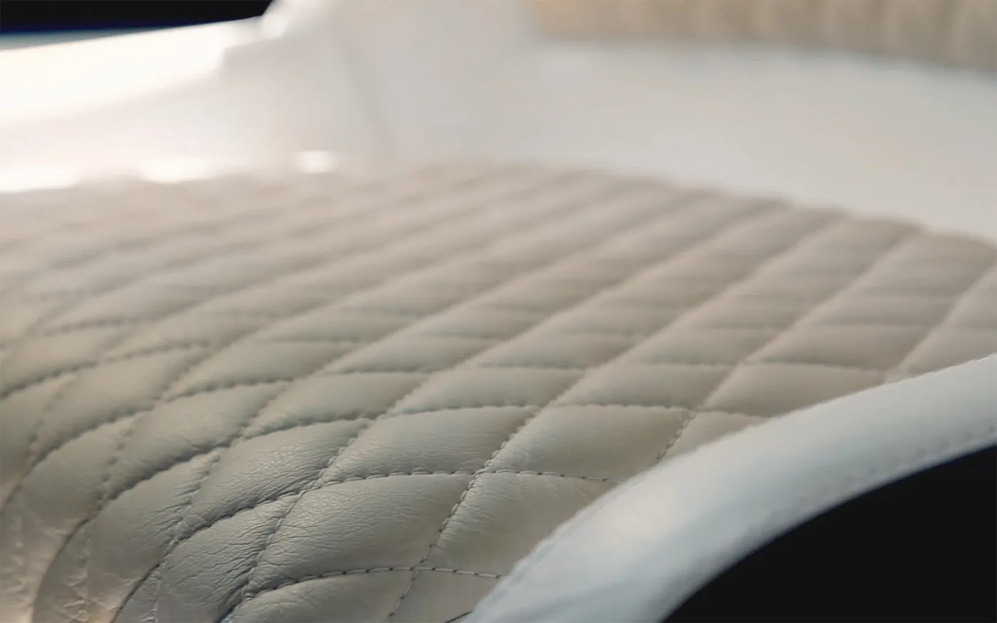 Hand-stitched quilted upholstery detail on the Schaefer V34