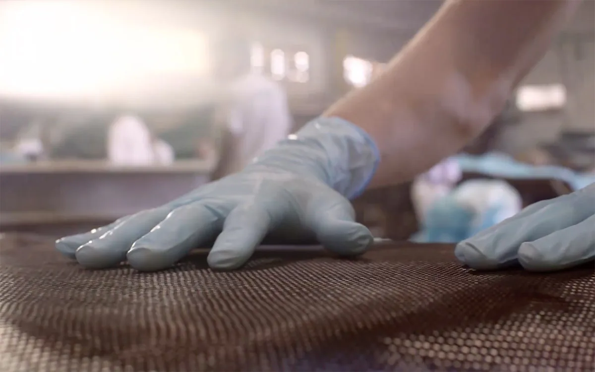 Carbon fibre being laid up by hand at the Schaefer shipyard