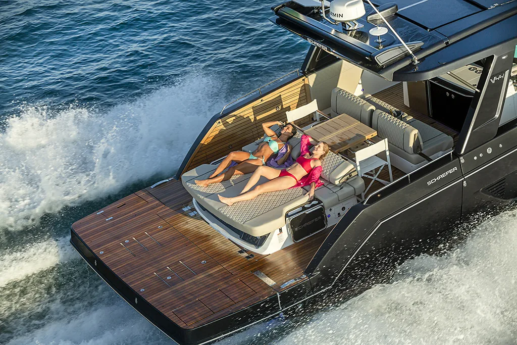 Aerial view over the stern of the Schaefer V44 underway with guests on the aft deck