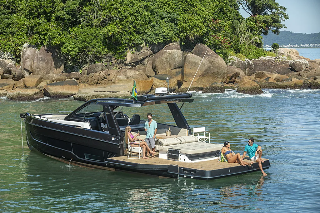 Schaefer V44 with balconies open in a tropical bay, guests relaxing on the platforms