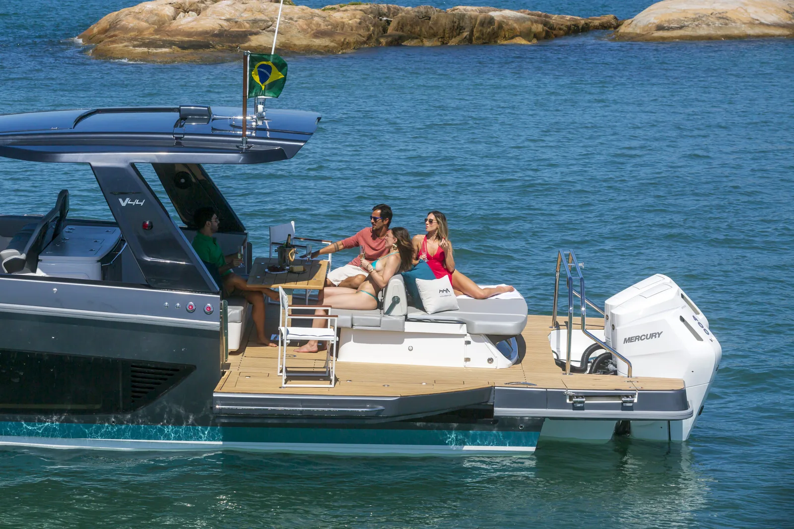 Schaefer V44 at anchor with a side balcony open and guests relaxing on deck