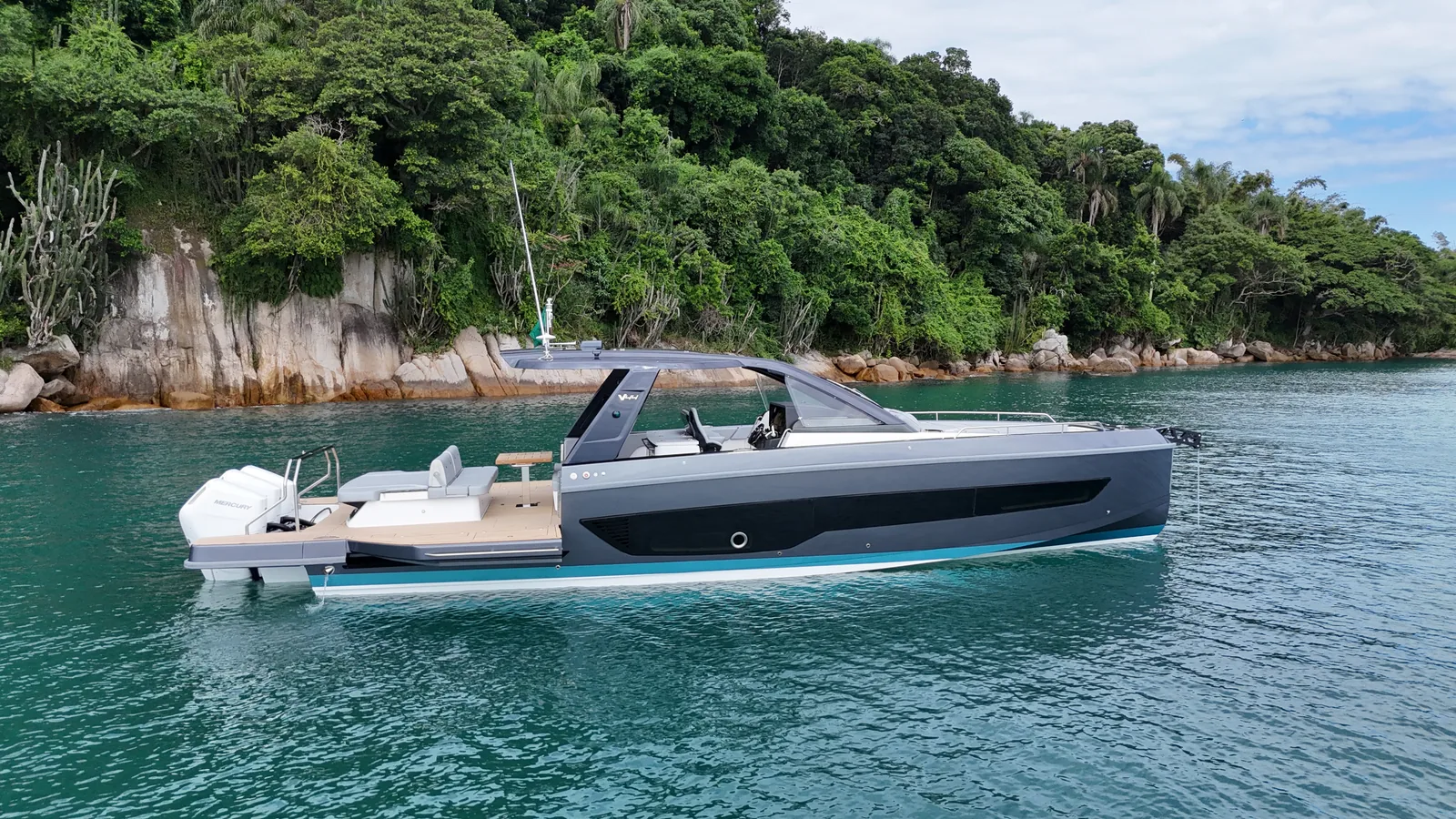 Schaefer V44 with grey hull at anchor in a wooded cove