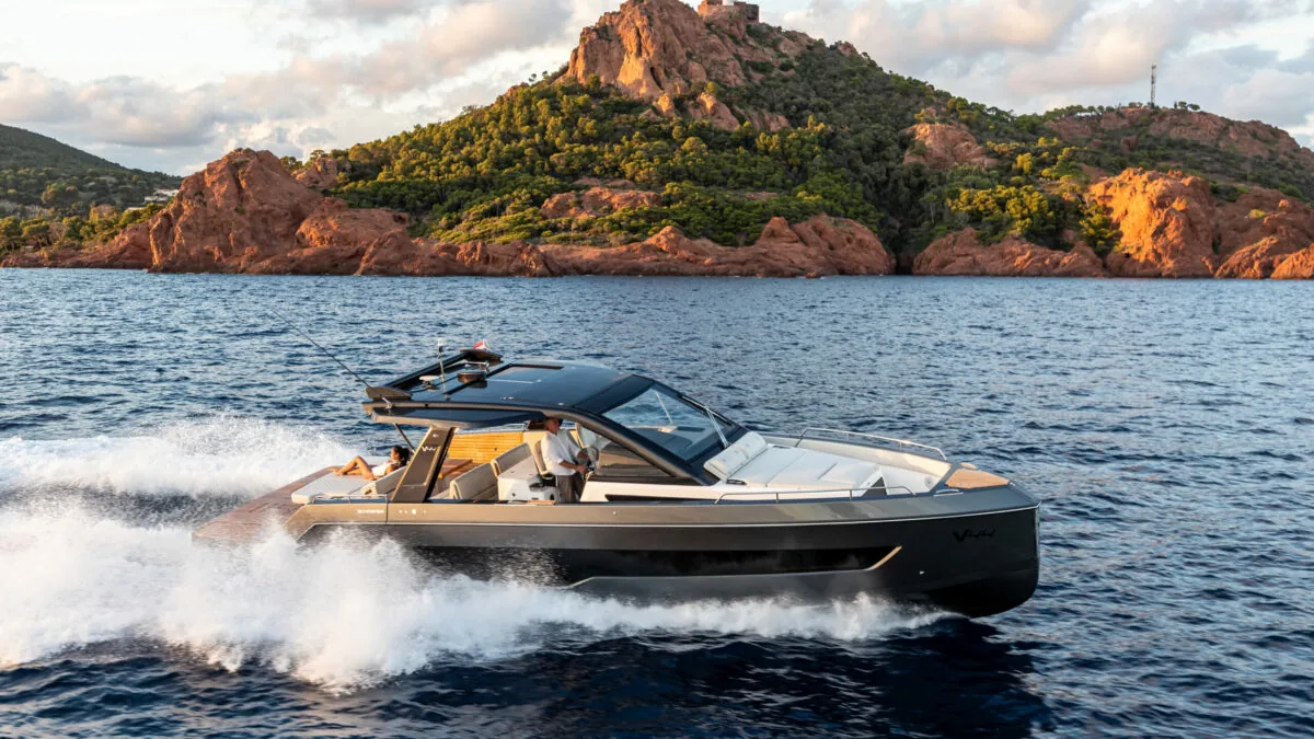 Schaefer V44 running past a red rocky coastline