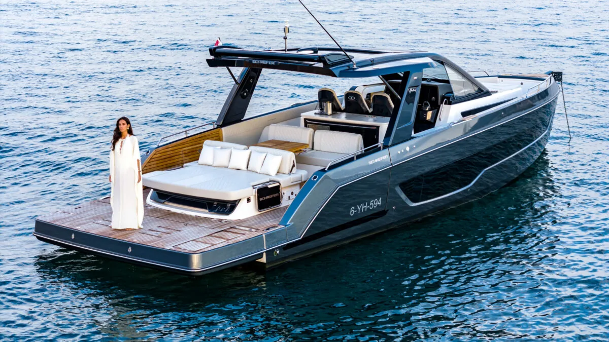 Schaefer V44 with balconies open at anchor, guest walking the deck